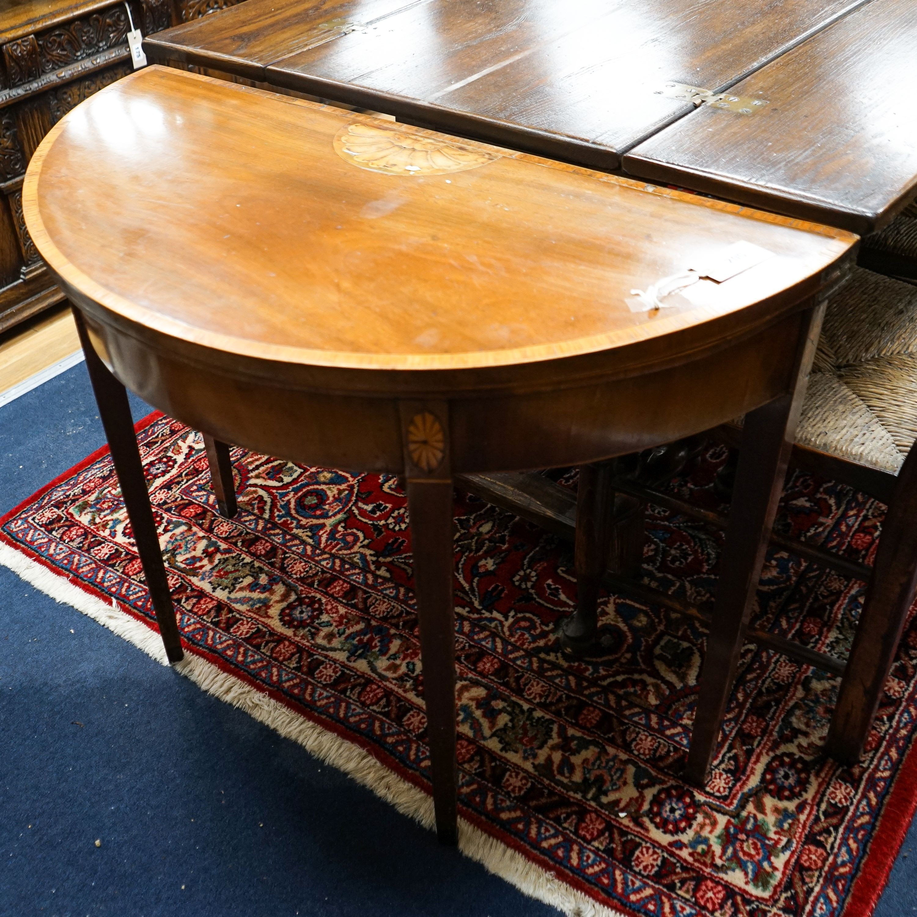 A George III inlaid and cross banded mahogany demi-lune card table with folding top, width 91cm, depth 44cm, height 72cm